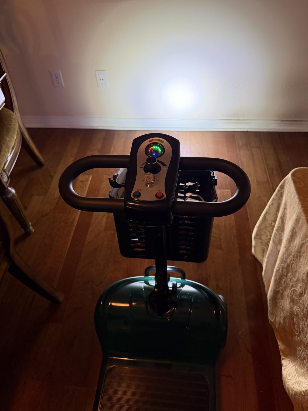 Close-up of the simple scooter control panel with speed dial and battery gauge